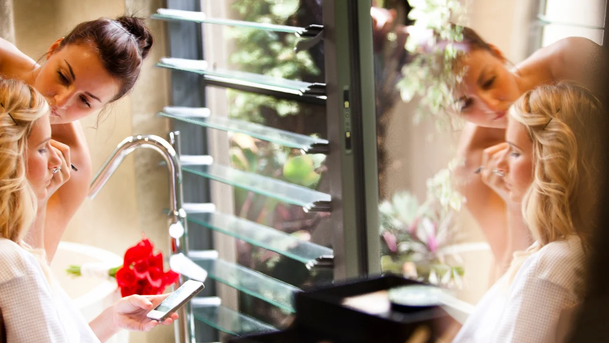 Gold Coast makeup artist applying eye makeup, reflected in a mirror